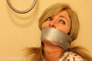 www.knottydamsels.com - Dakkota Grey Photoset: Fun With Gags Part 2: Wraparound Tape Gagged thumbnail